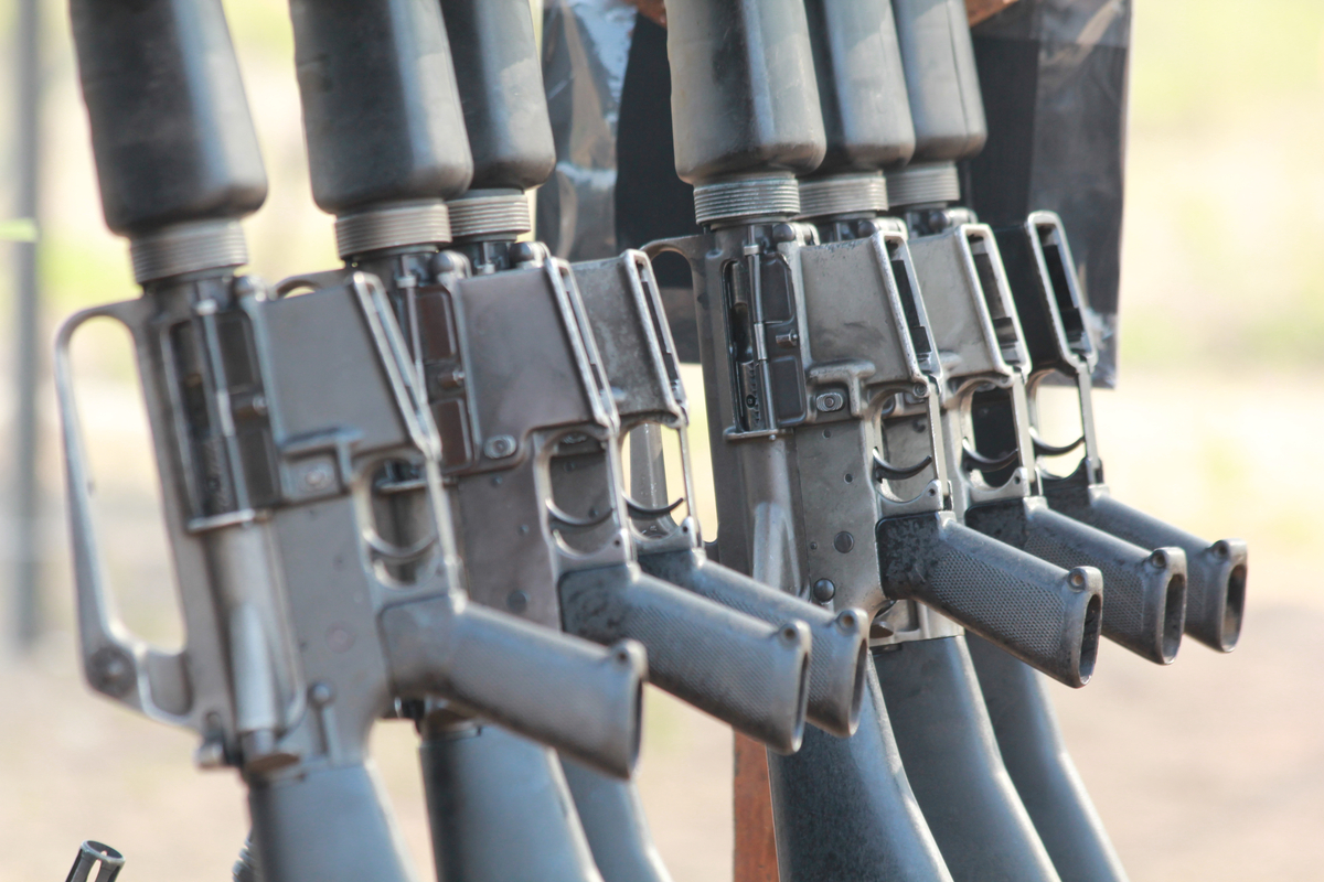 Row of black rifles displayed side by side